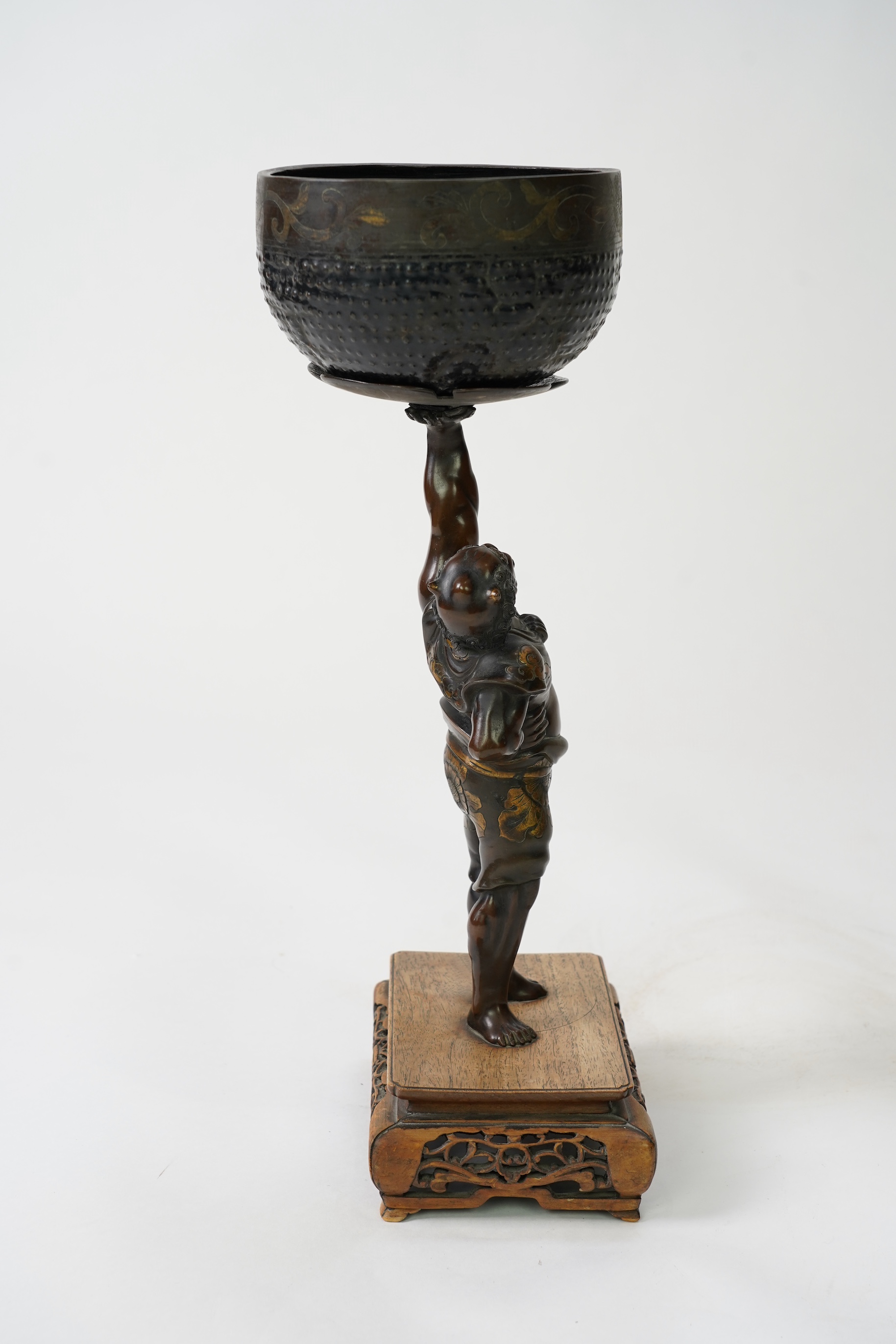 A Japanese bronze figure of an Oni holding a temple bell aloft, Meiji period, in Miyao style